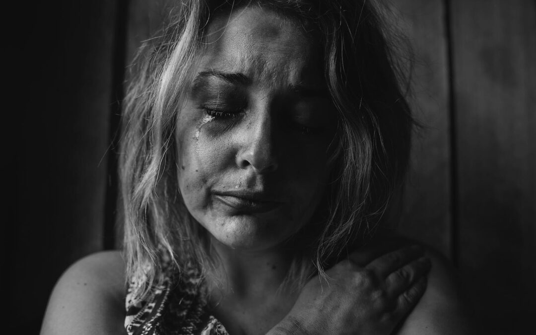 A black and white image of a sad and unhappy woman indicating depression.